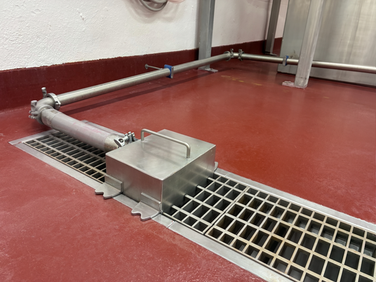 trench hog on trench drain inside facility with coated floors