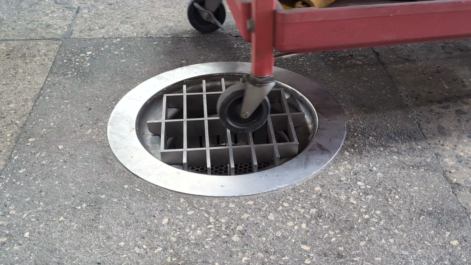 floor drain with hand cart rolling over it