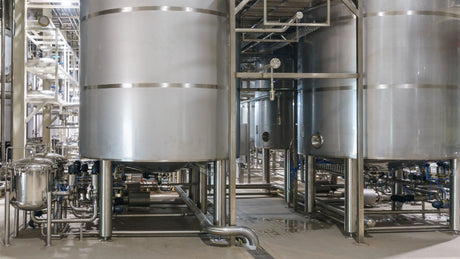 Large manufacturing tanks and trench drains within a pharmaceutical facility