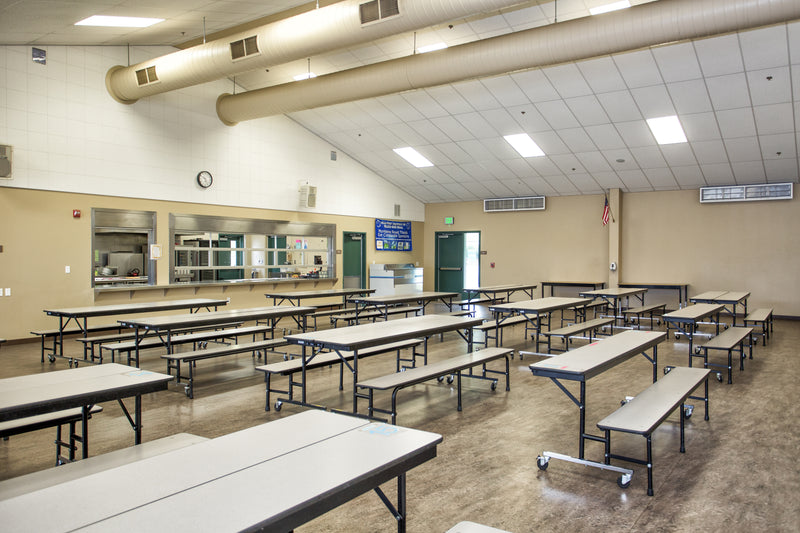 School cafeteria with many tables and a serving window