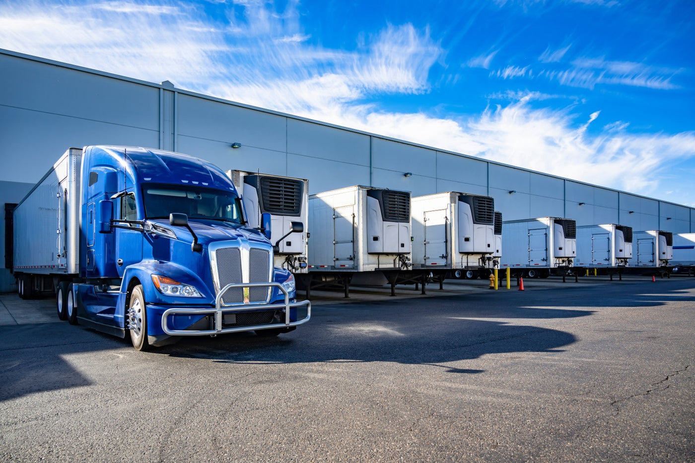 Loading area with truck and trailers at a very large building.