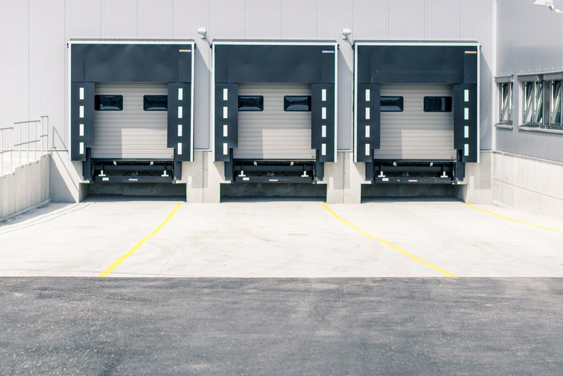 Three bay loading dock with closed overhead doors.