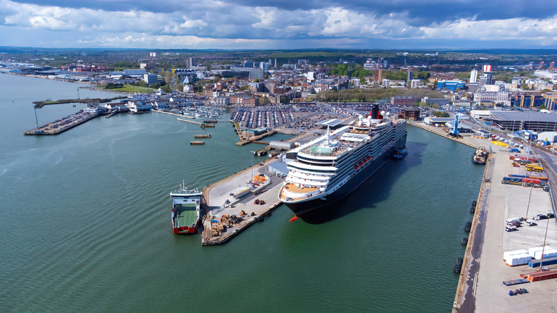 Aerial view of a large port with a large cruise ship.