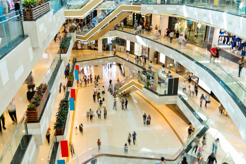 Aerial view of a multi-level shopping mall with many shoppers