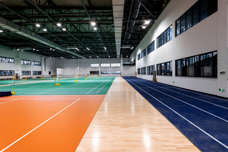 Large sports complex with racket courts and running track.
