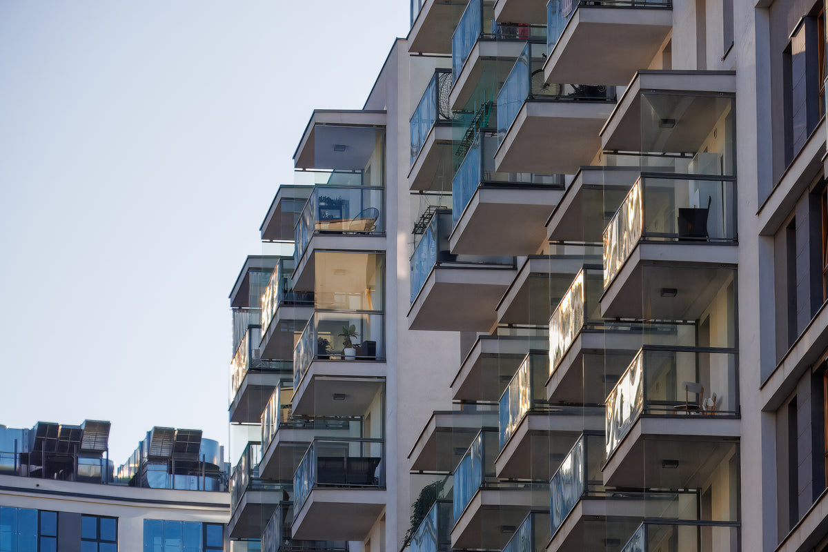 multi-family apartment building showing balconies with glass railing
