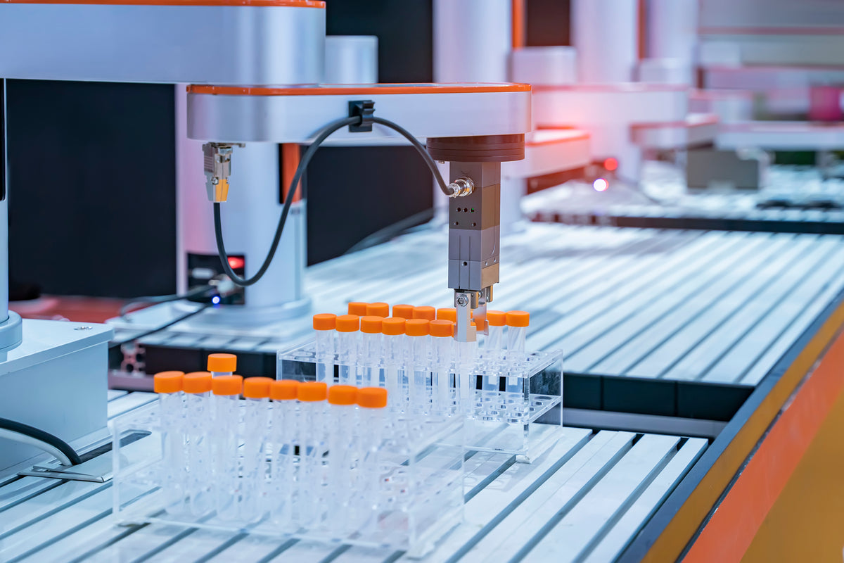 Automated robotic arm handling test tubes in a high-tech laboratory environment.