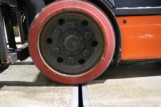 fork lift driving over slot drain