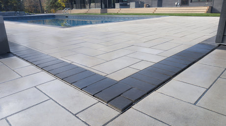 outdoor patio with pool and paver stones
